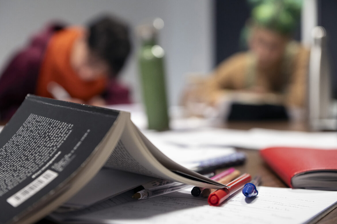 FRANCE – WRITING WORKSHOP – AN OPEN BOOK, PENS AND NOTEBOOKS