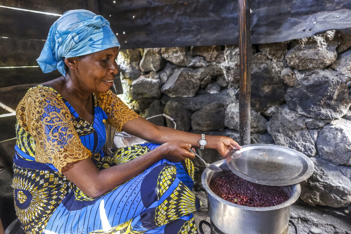 Woman sitting and cooking in her kitchen in Bukavu, DRC
