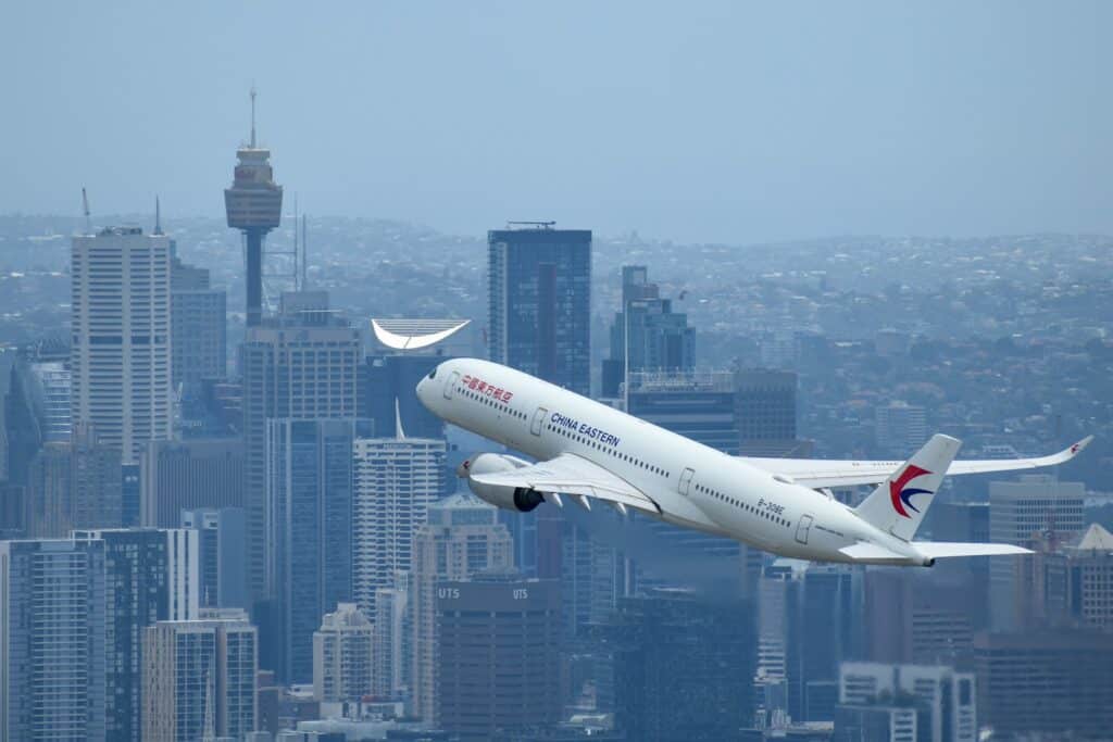 A large passenger jet flying over a city