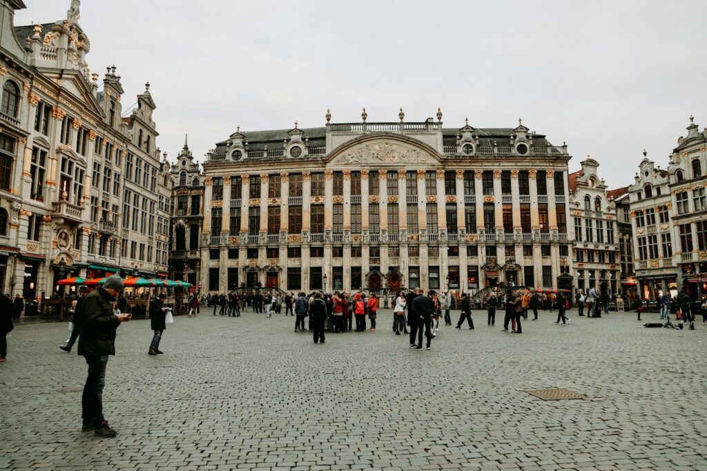 A group of people walking around a large building