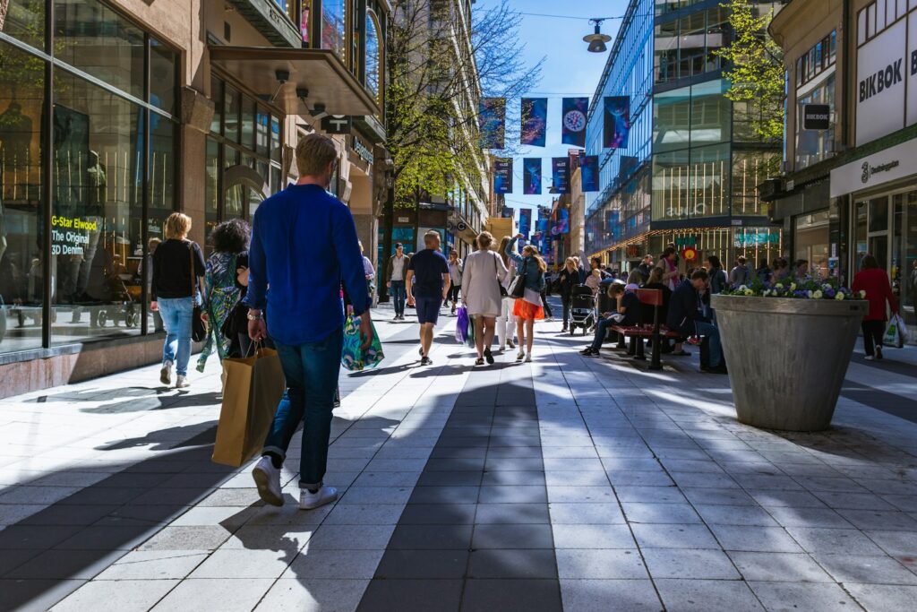 people walking in between buildings during daytime
