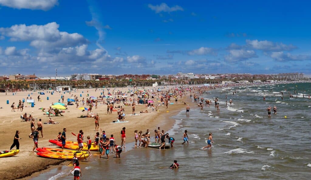 A crowded beach with many people on it