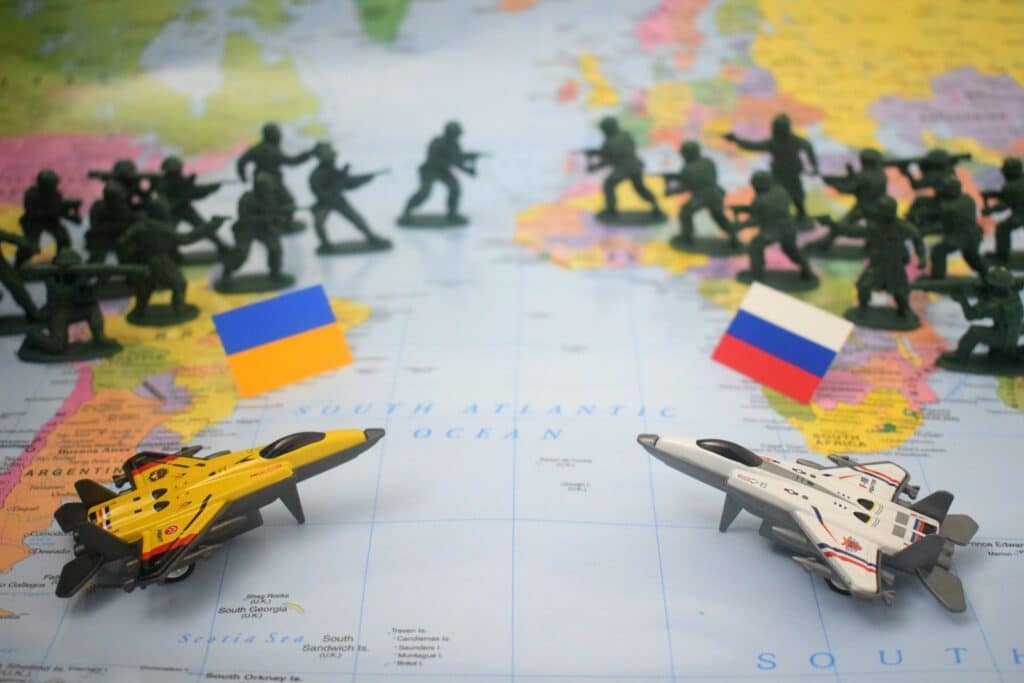 Toy soldiers and jets on world map with flags