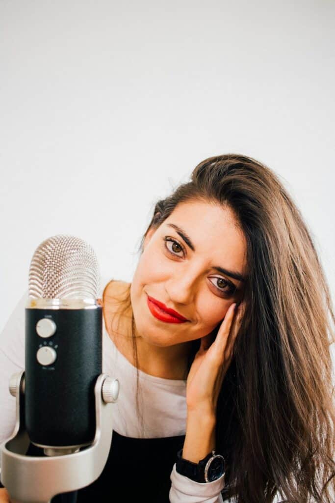 smiling woman beside microphone