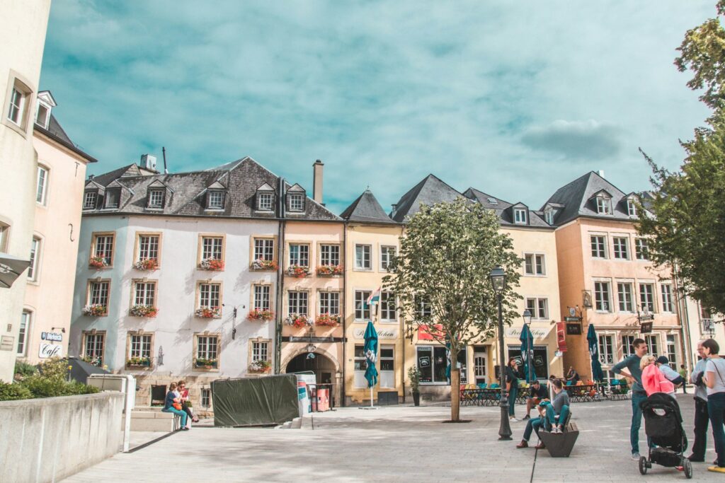 people gathered by buildings during daytime